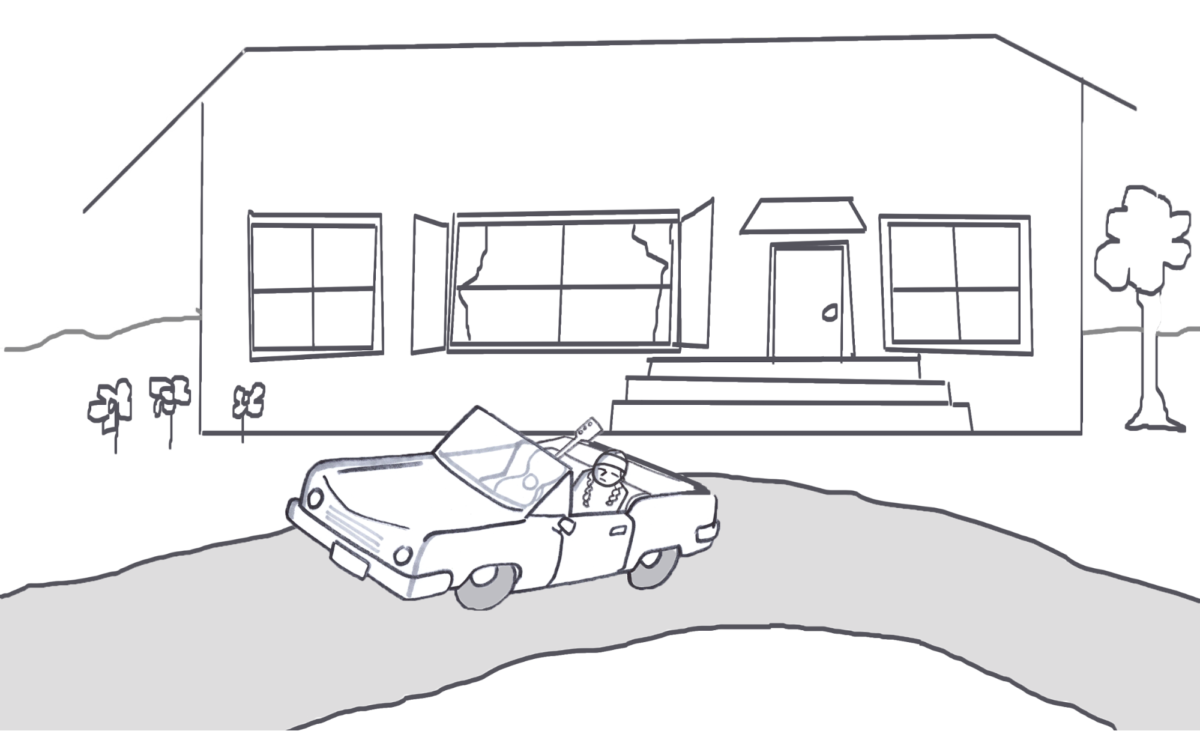 A person sitting in a car in the driveway