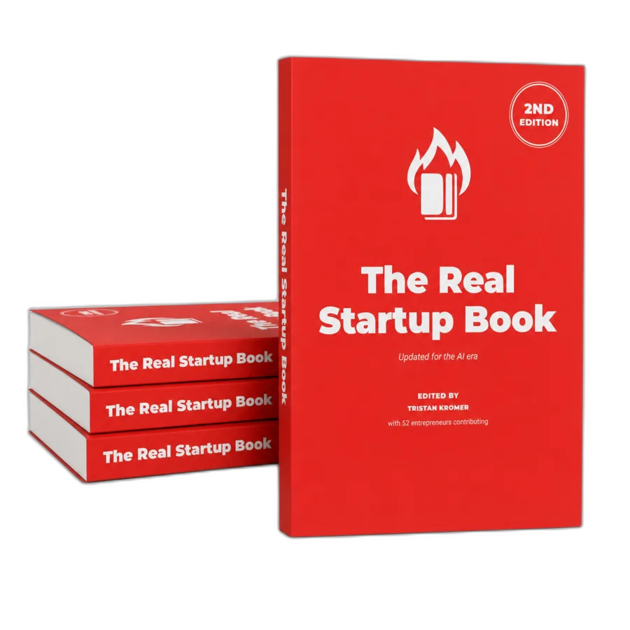 A stack of The Real Startup Book, 2nd Edition